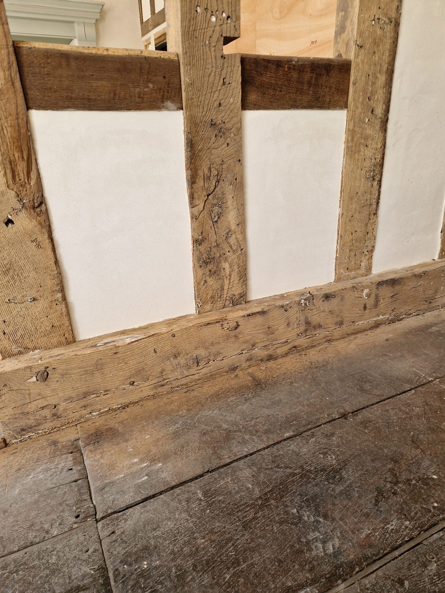 Completed lime plaster panels within an exposed oak frame